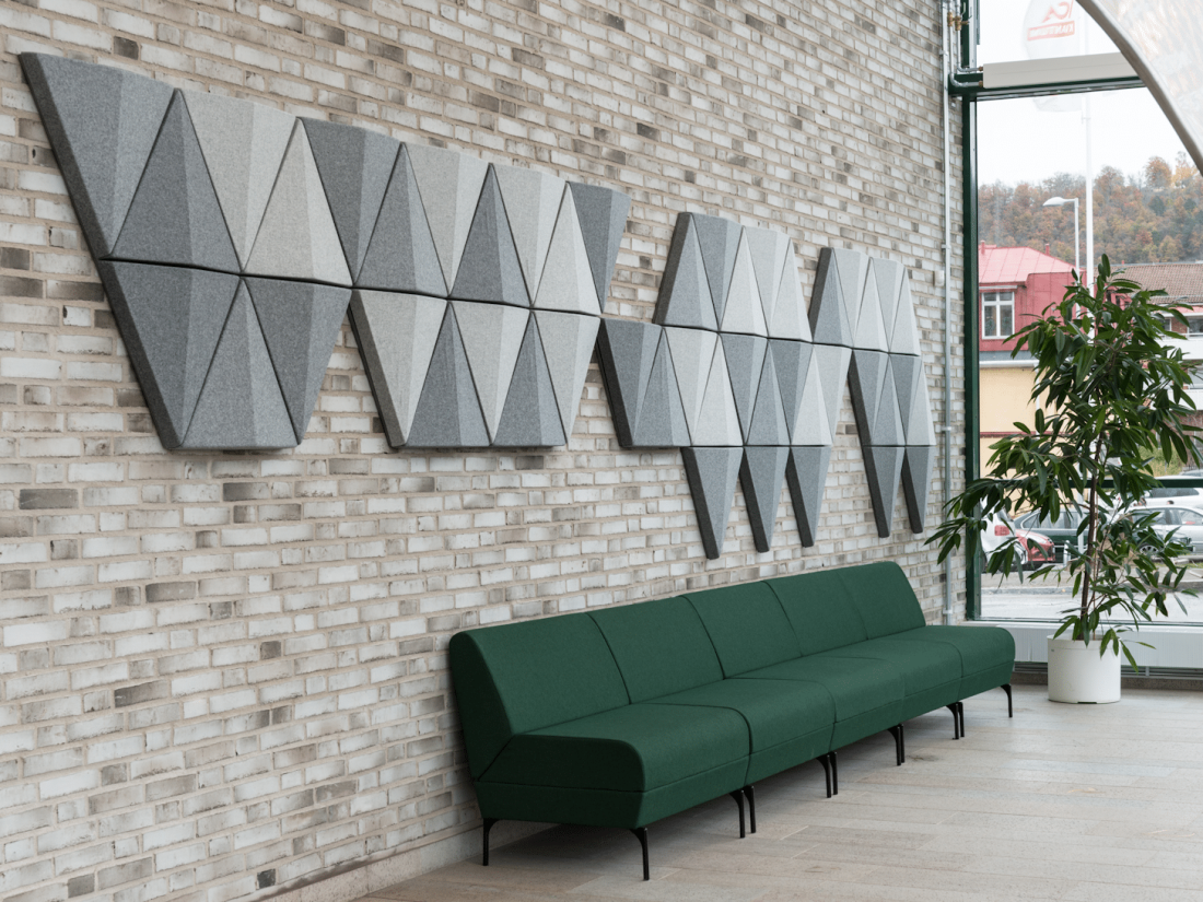 Vægpanel Bits i grå på murstensvæg over sofa